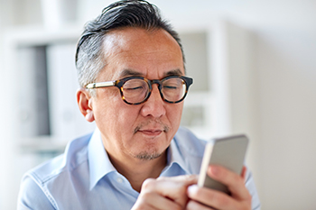 image of man looking at his cell phone disappears from page